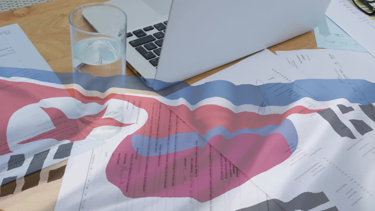 документы и ноутбук на столе с абстрактной анимацией красочных волн над ними