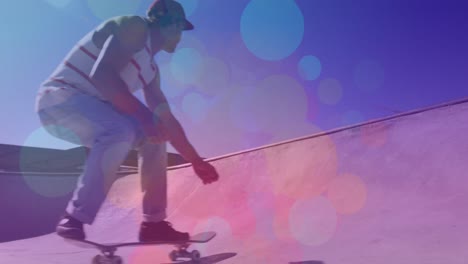 animation of colourful spots over caucasian man skateboarding