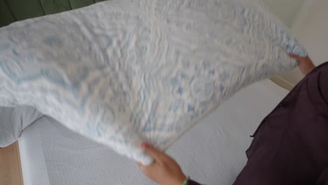 unmade bed with patterned comforter