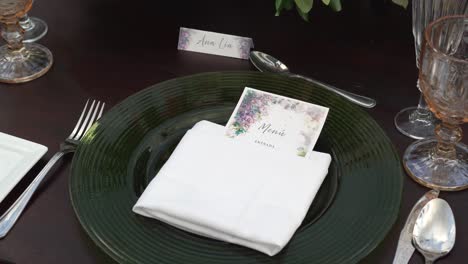 wedding invitation on table set for outdoor wedding reception