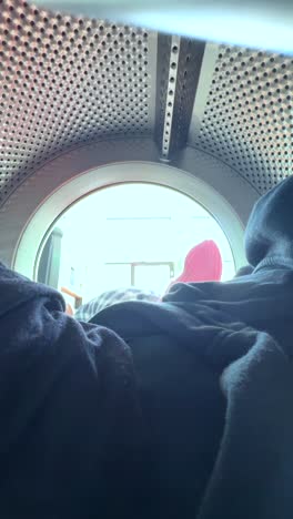 teenager loading clothes into a washing machine