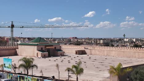 wide shot of qara prison in meknes, morocco, featuring a construction crane, highlighting urban development and historical preservation