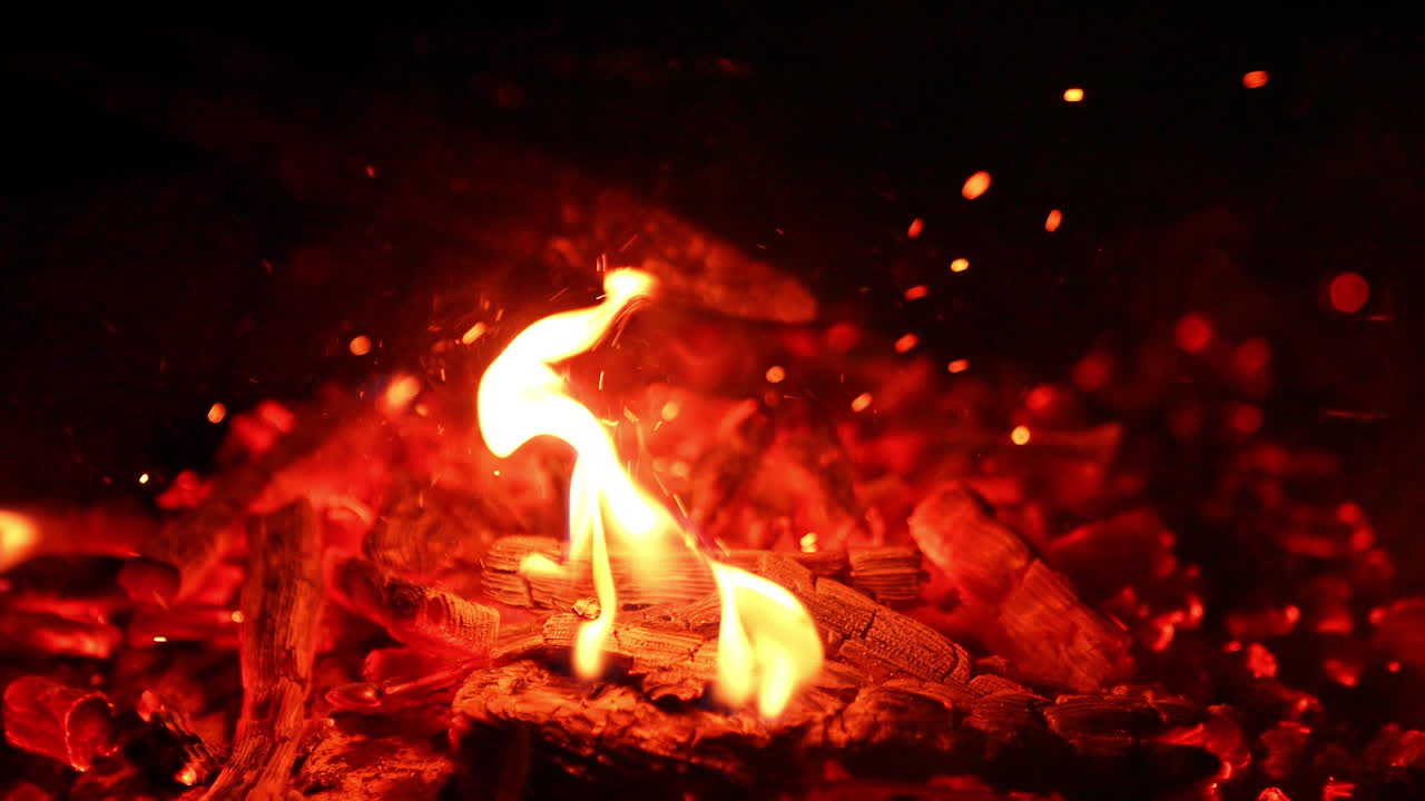 Red flaming on a firewood. Burning logs close up view.