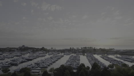 Aerial-drone-footage-of-Burnham-Harbor-in-Chicago,-Illinois-on-Lake-Michigan-at-sunrise-in-October-fall