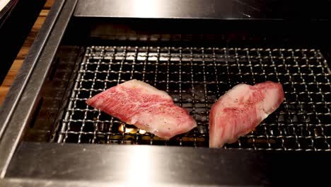 steak pieces cooking on a grill, changing color