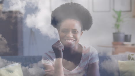 Animation-of-sky-with-clouds-over-african-american-woman,-slow-motion