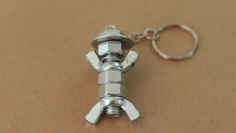 llavero de plata hecho a mano para parecerse a una figura con sombrero, hecho de tuercas y pernos