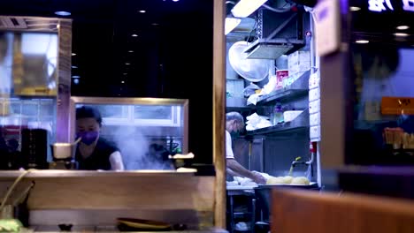 chefs cooking in a bustling hong kong kitchen