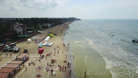 aerial view of beach with tourists, sunbeds and umbrellas at a luxury hotel. sea travel destination.