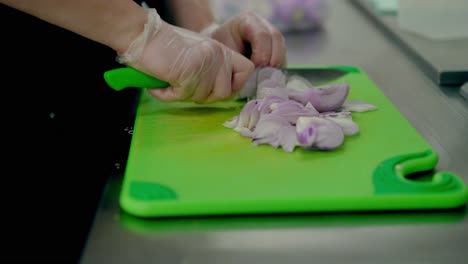 Cook-very-quickly-cuts-a-purple-onion-on-a-cutting-board