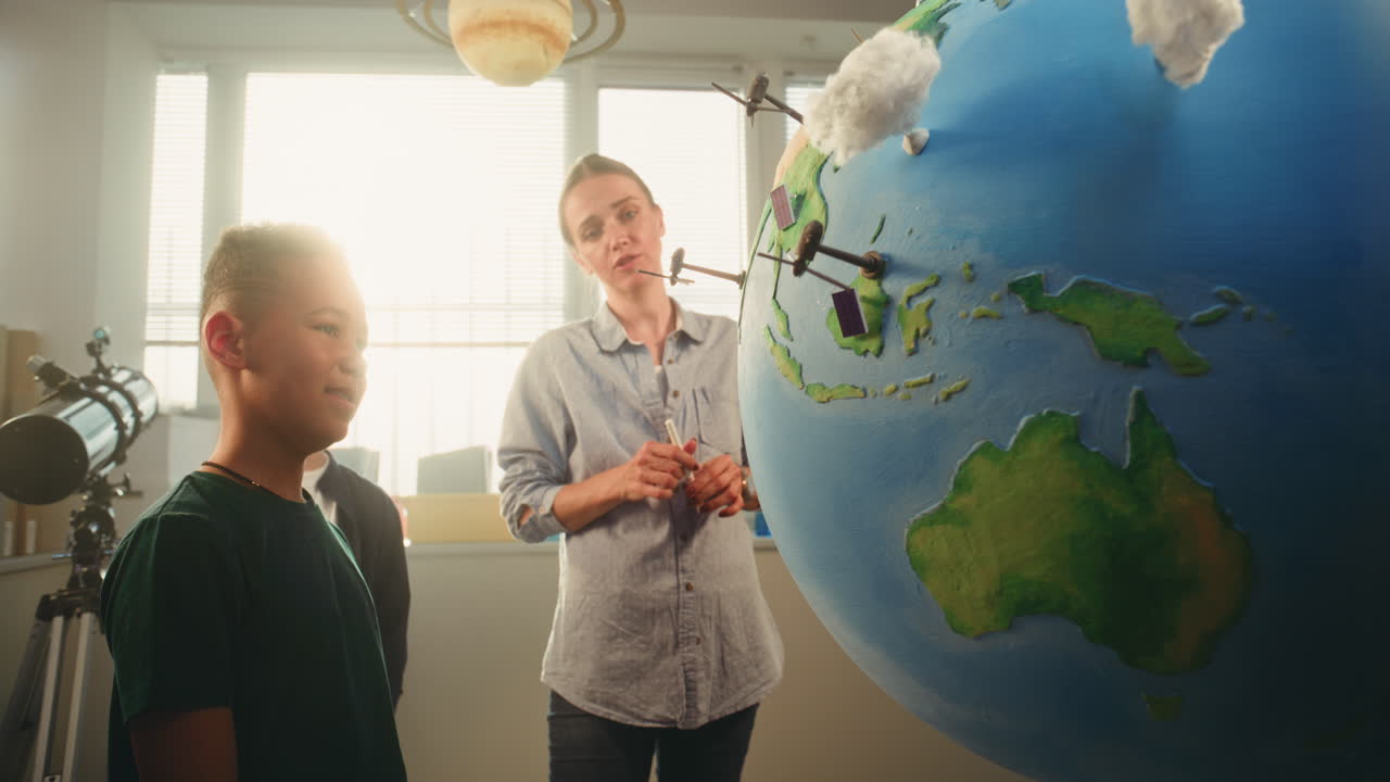 STEM Class School Boy Presenting Renewable Energy Sources Using Model of Planet Earth