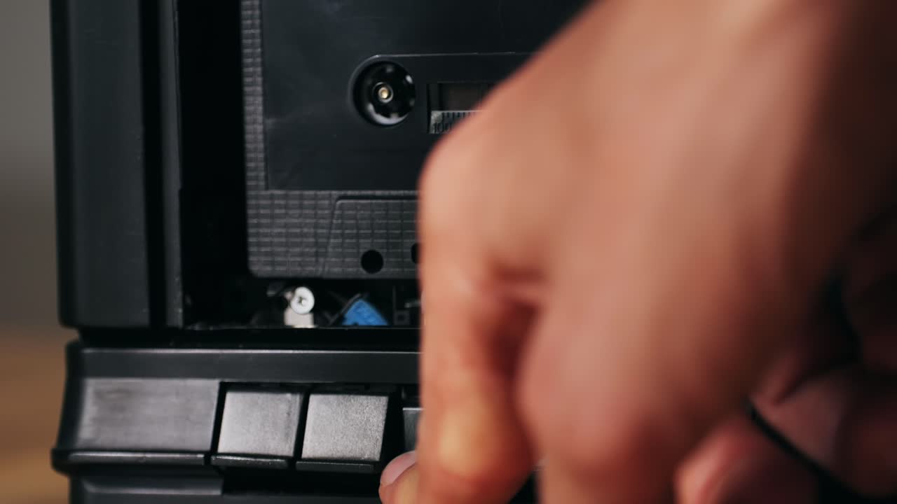 Inserting Cassette Tape into Player