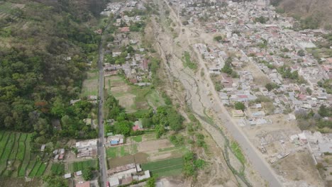 Aerial-flyover-the-town-of-Panajachel-in-Guatemala-panning-up-to-reveal-Lake-Atitlan