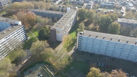 aerial of social housing flats with green parks in autumn