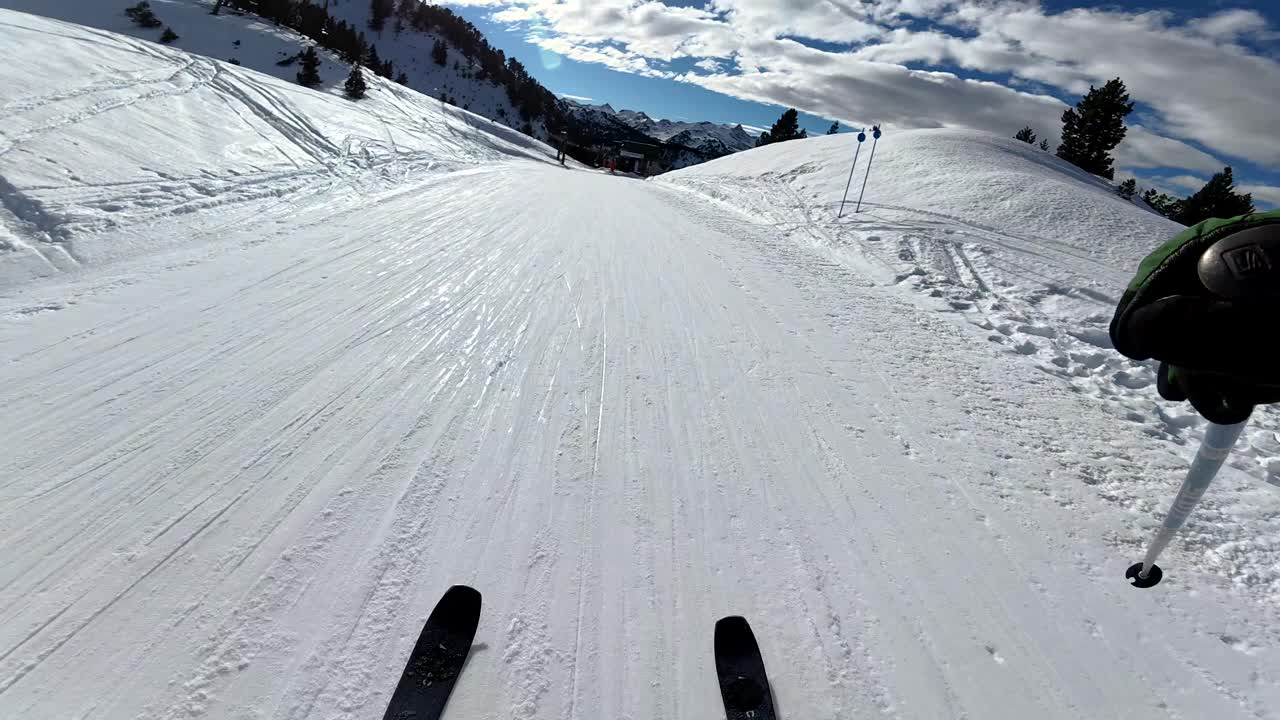 Skiing down a snowy slope in the mountains