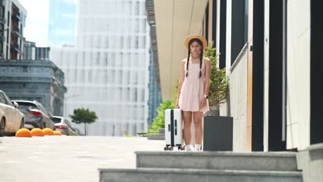 woman with suitcase leaving a building