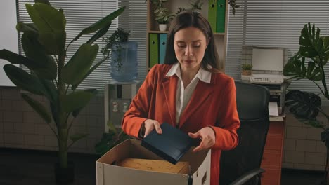 woman packing her belongings in an office