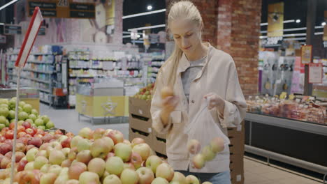 woman shopping for apples at a supermarket