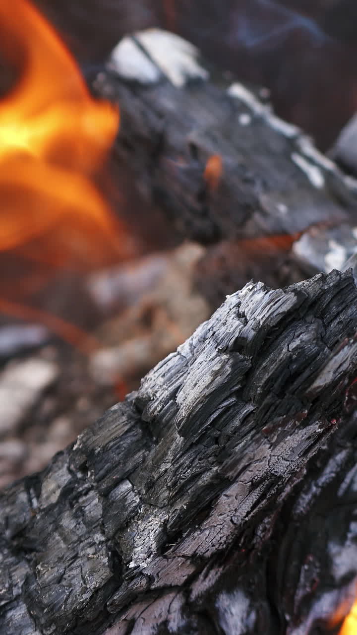 Firewood in flame closeup. Detailed close up of warm fire with tongue of flame