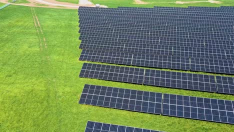 aerial view of big sustainable electric power plant with many rows of solar photovoltaic panels for producing clean ecological electrical energy