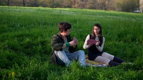 couple playing cards in a park