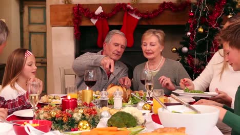 familia de tres generaciones teniendo la cena de navidad juntos