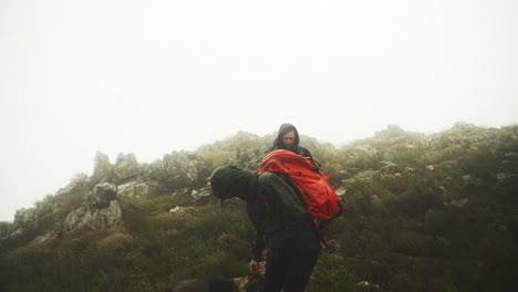 two young men hiking with their dog outdoors