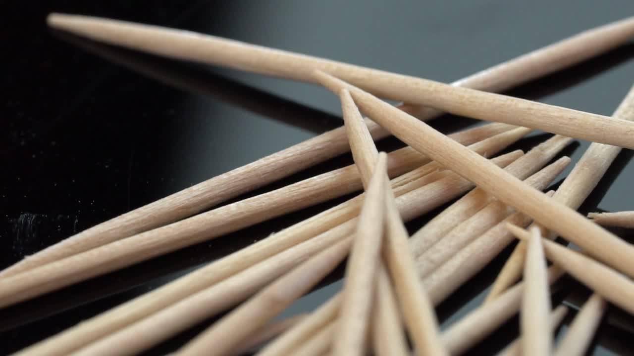 Close-up of pointed wooden chopsticks. Zoom out