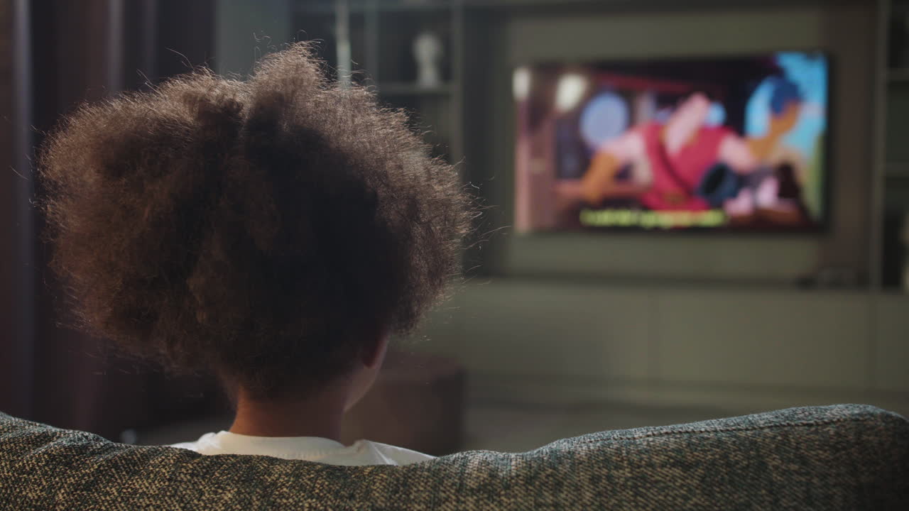 Kid watching film at home