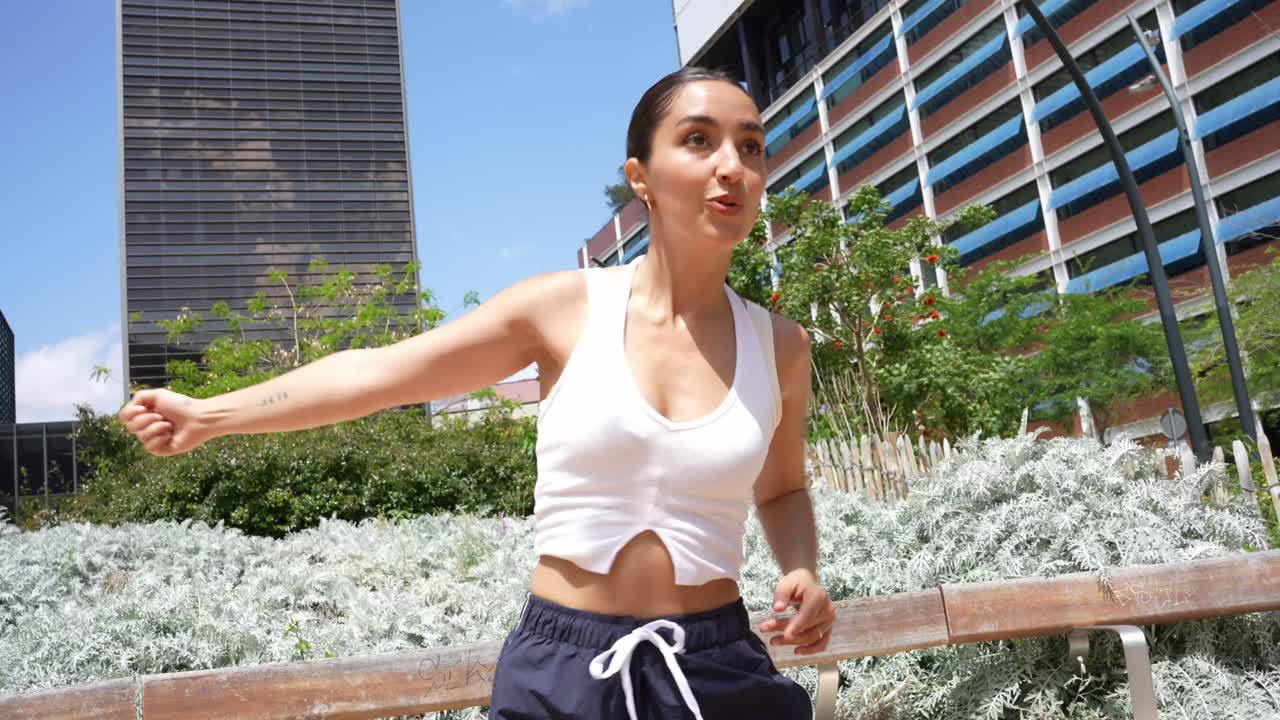 Woman dancing outdoors in an urban setting