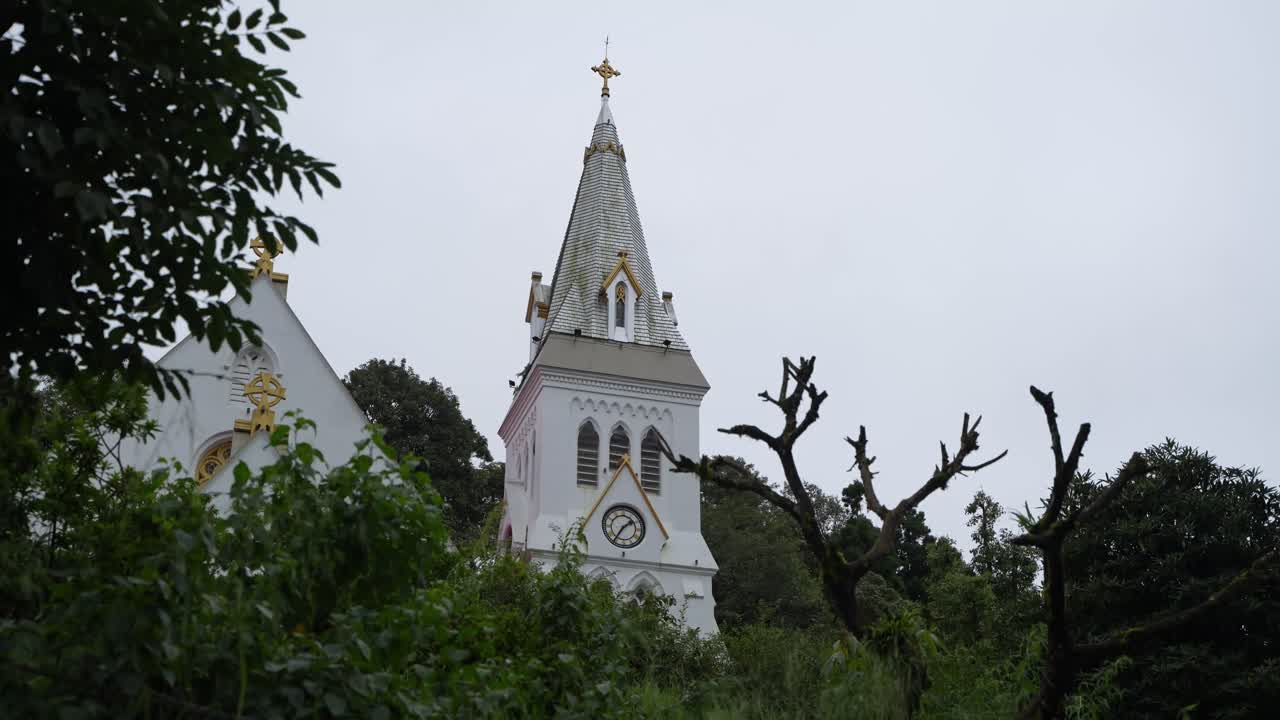 There is a church on the top of the mountain. It is located in Darjeeling
