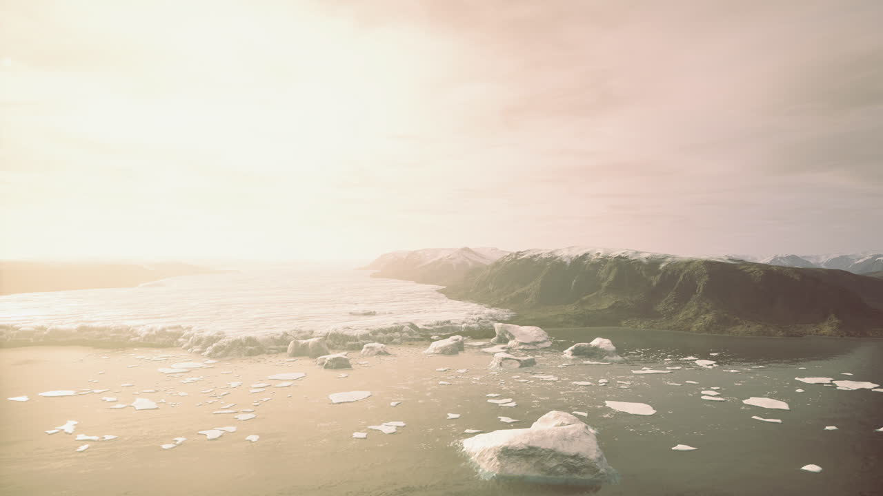 Glacial serenity envelops the coastline under a warm golden sky