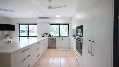 dolly in white luxurious rural property home kitchen with gas stove top dishwasher and black accent metal siding and handles