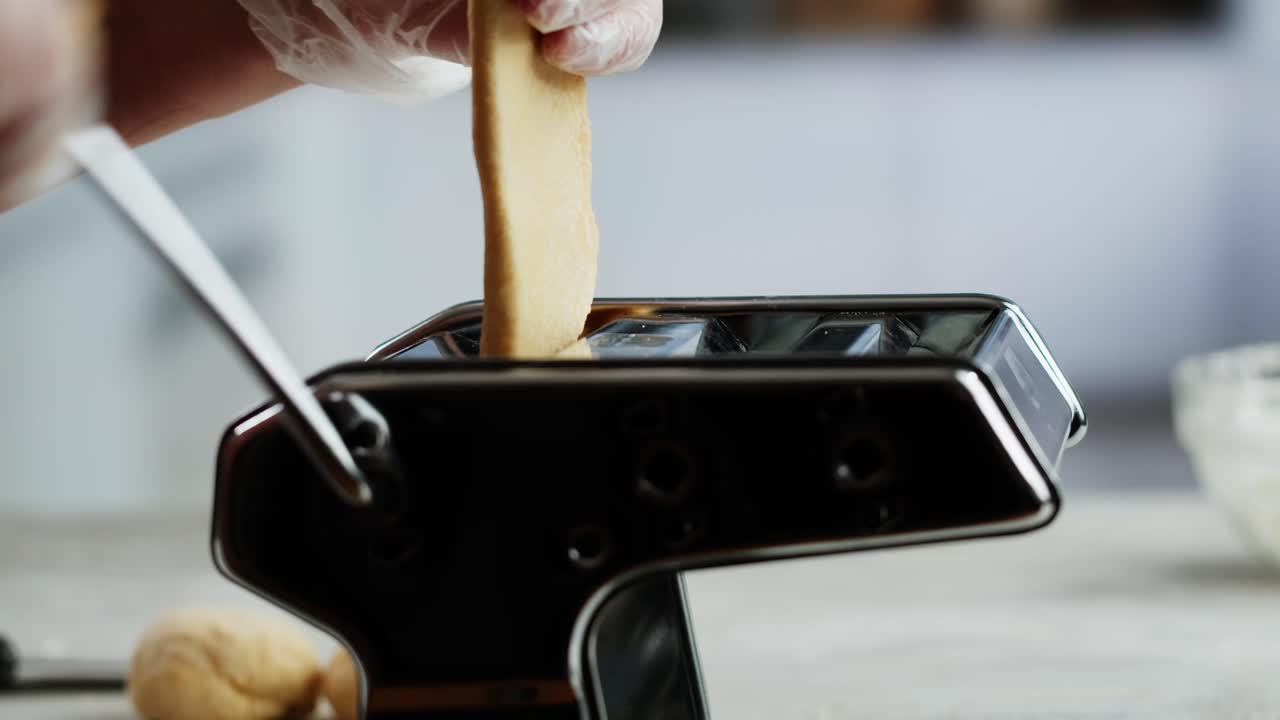 Close-Up of Hands Making Fresh Pasta with a Manual Machine