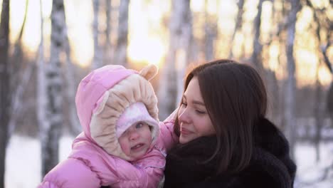 mother and baby in winter park