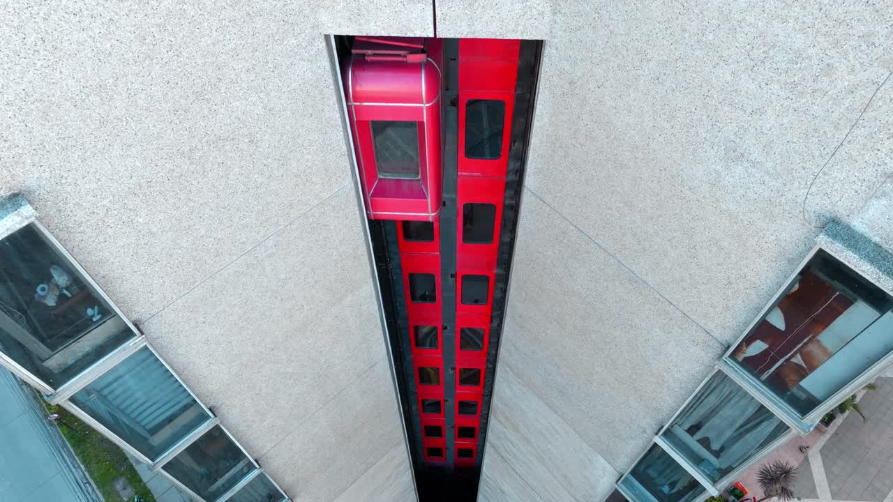 Aerial view of an vintage red elevator in a building, drone shot