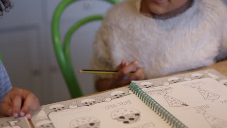 two children doing homework at kitchen table shot on r3d