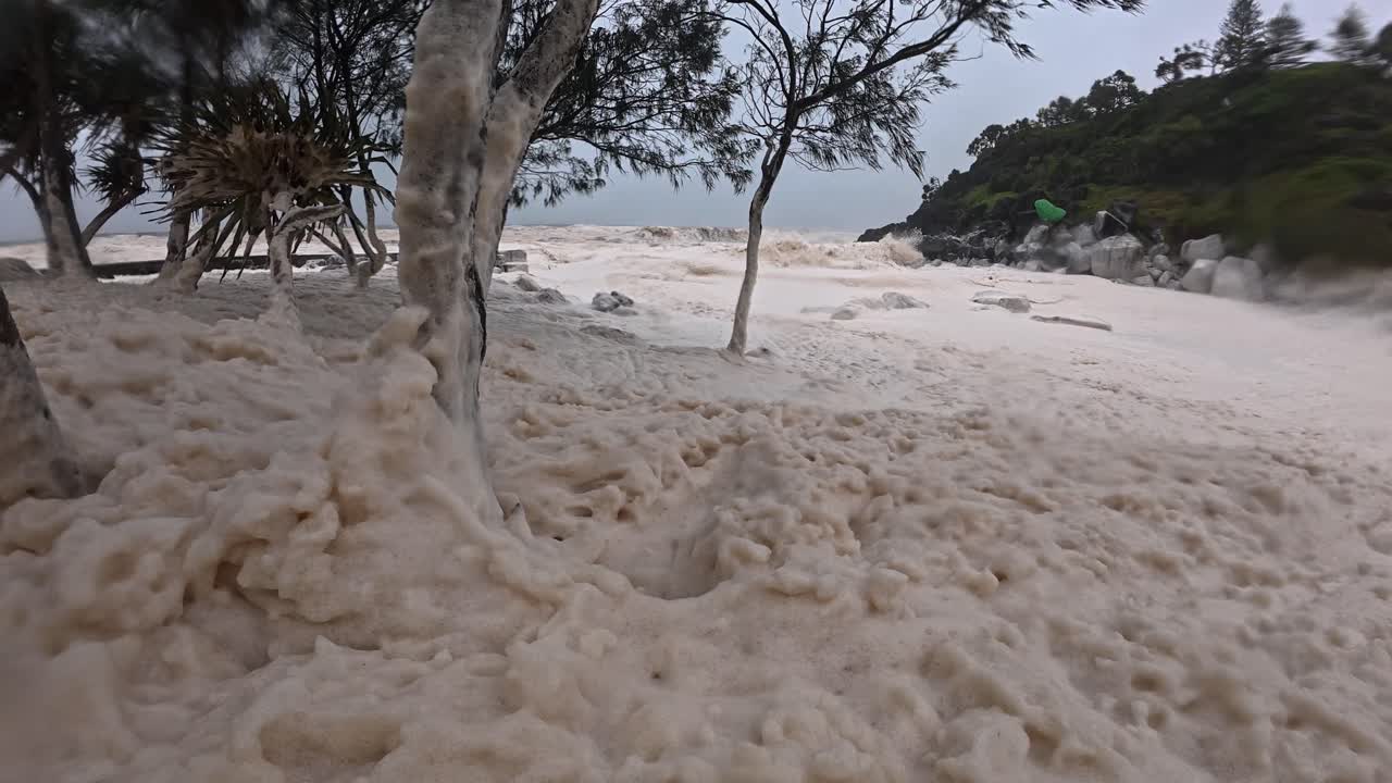 Spumes Covering Froggy Beach With Strong Wind Blowing. Cyclone Alfred In Gold Coast, QLD, Australia. static shot