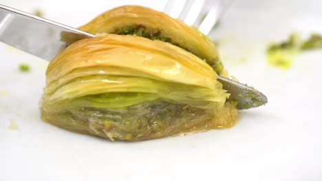 eating turkish baklava with pistachio, traditional dessert