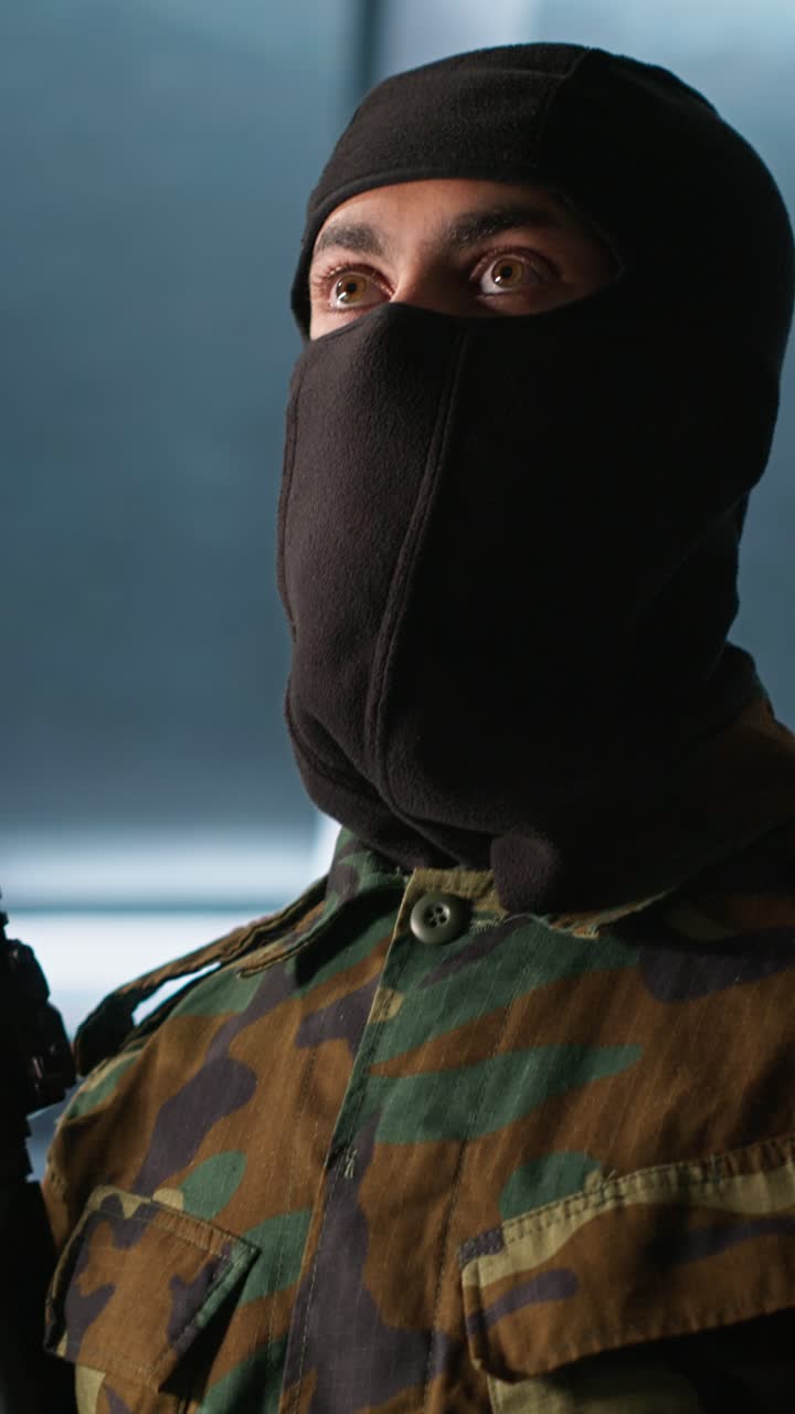 Vertical video Insurgent inspecting room during enemy base assault
