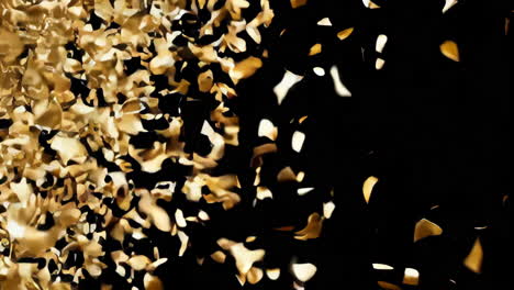 golden confetti falling on black background