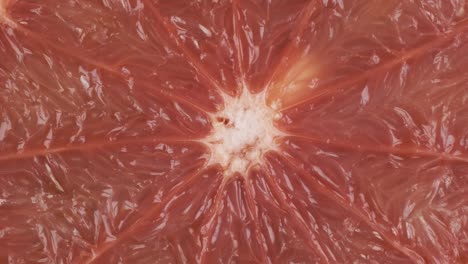 rotation, closeup of fresh, juicy pulp of an grapefruit. background and texture of grapefruit. top view.
