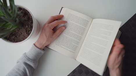 man turning the pages of a book