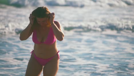 curvy woman in pink bikini at the beach
