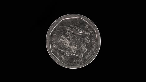 jamaica 1996 5 dollars coin obverse with national coat of arms rotating on black background