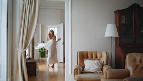 carefree lady enjoying morning cozy interior. positive girl dancing at home