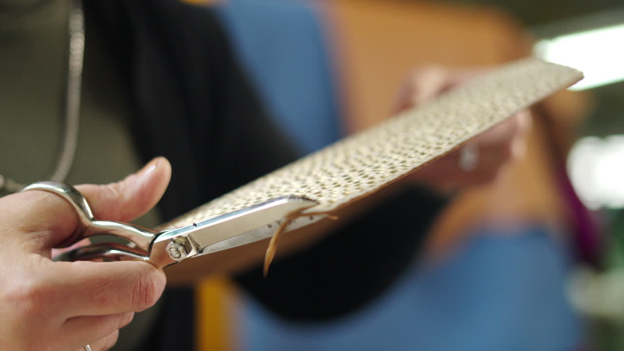 Cutting leather with scissors