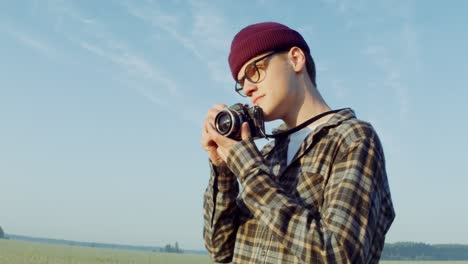 man taking a picture with a vintage camera