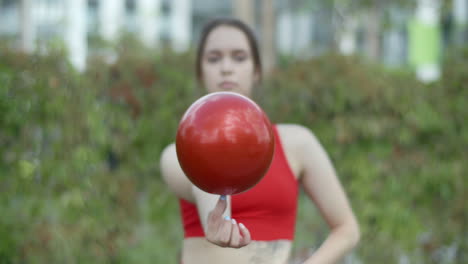 woman juggling a red ball