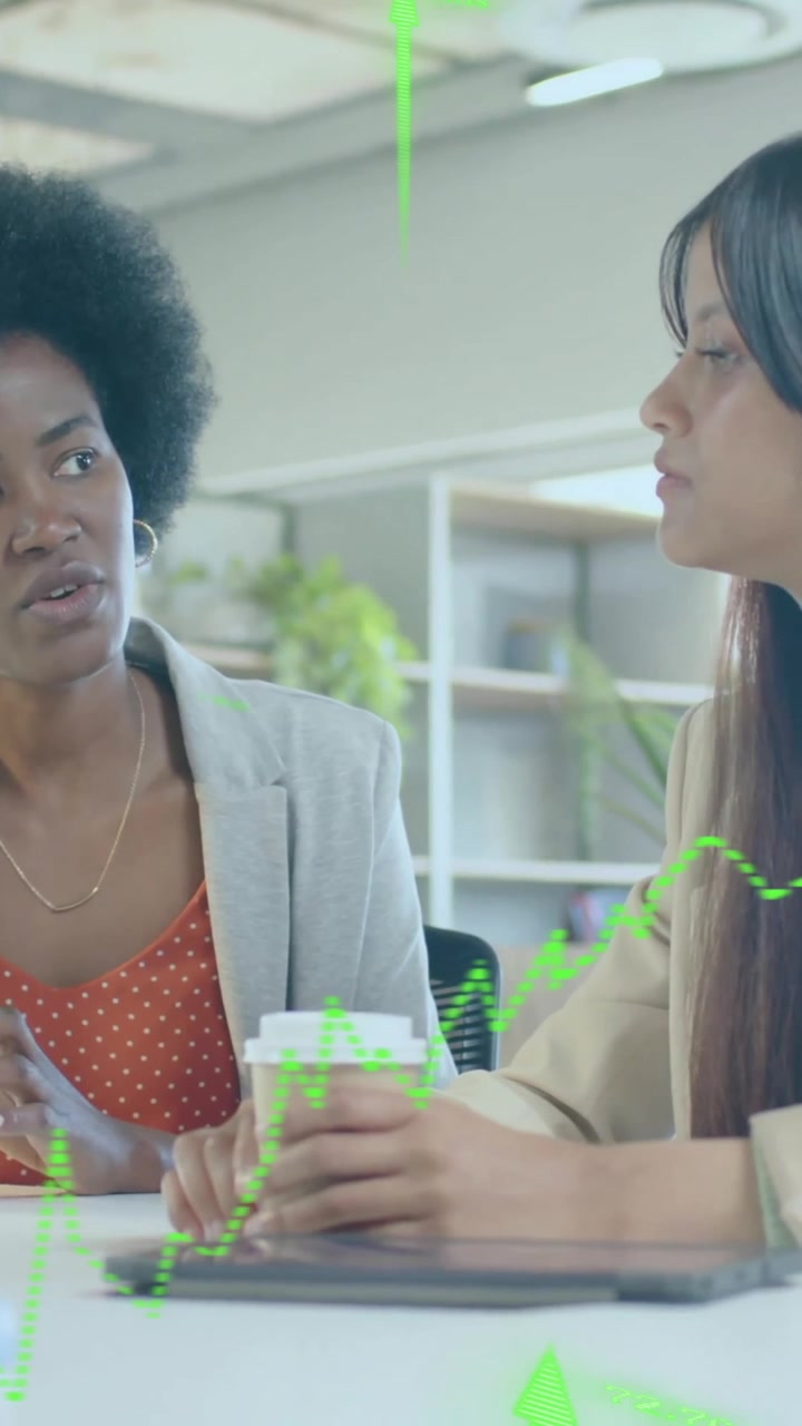 Animation of financial data processing over diverse businesswomen in office